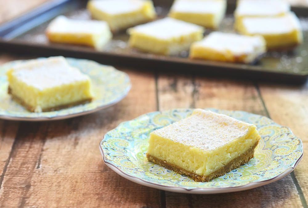 Calamansi cheesecake squares dusted with powdered sugar