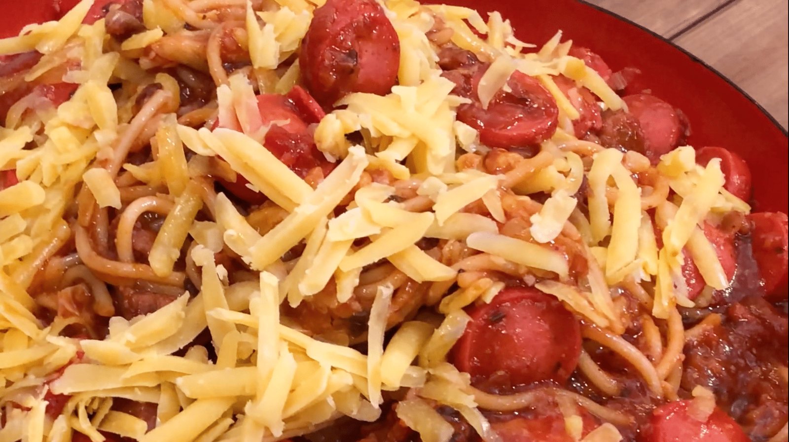 Filipino-style sweet spaghetti with hot dogs and shredded cheese