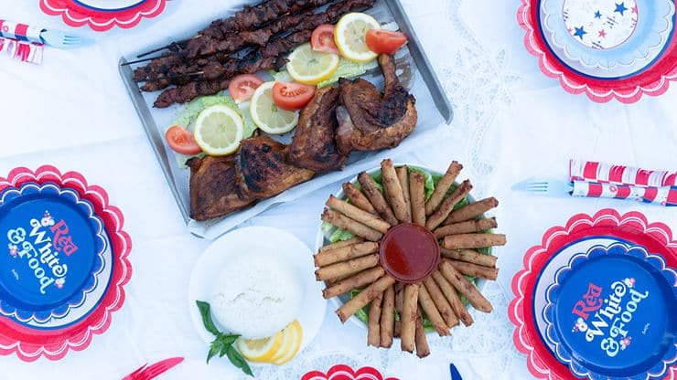 Grilled chicken inasal and pork skewers on a festive party table